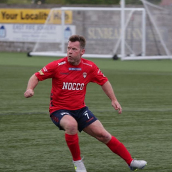 A player in red running with the ball