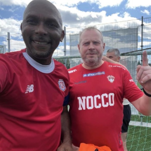 Two players in red shirts smiling for the camera