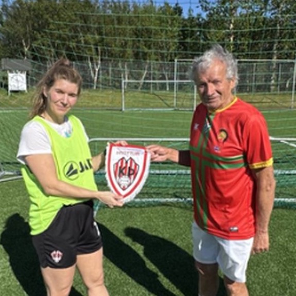 Two captains exchanging a club pennant before kick-off