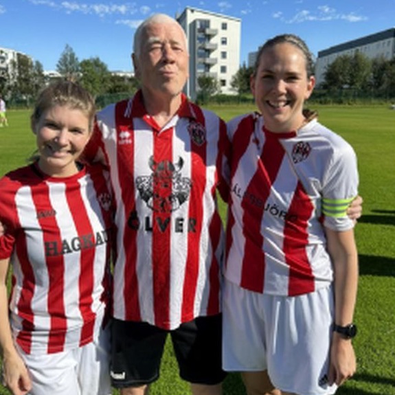 Three players in red and white striped shirts smiling