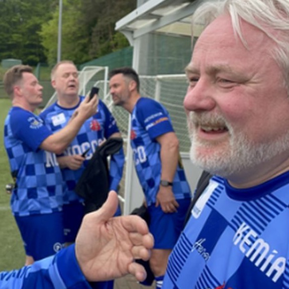 A player in blue giving a thumbs up